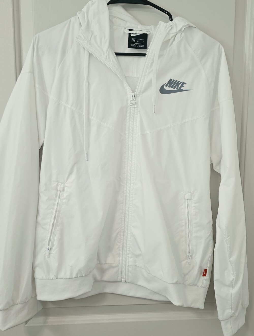 Nike Sportswear Windrunner hooded jacket with a dark grey logo on the chest.